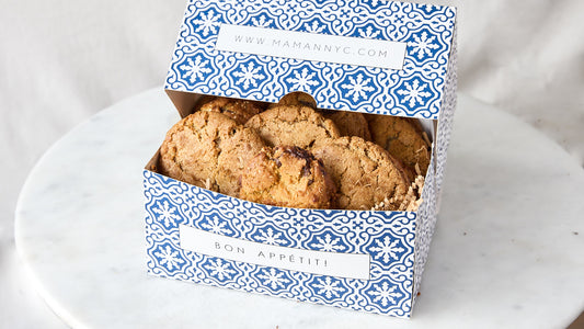 8 cookies in a rectangular blue and white box. 