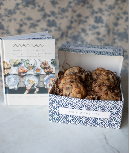 A blue and white pastry box of nutty chocolate chip cookies alongside the 'Maman: The Cookbook'. 