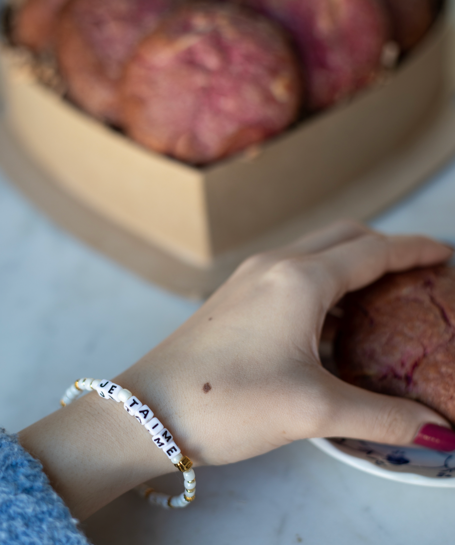 Heart-shaped box with nutty chocolate chip and white chocolate raspberry rose cookies; tied with pink ribbon - featuring je taime little words project bracelet