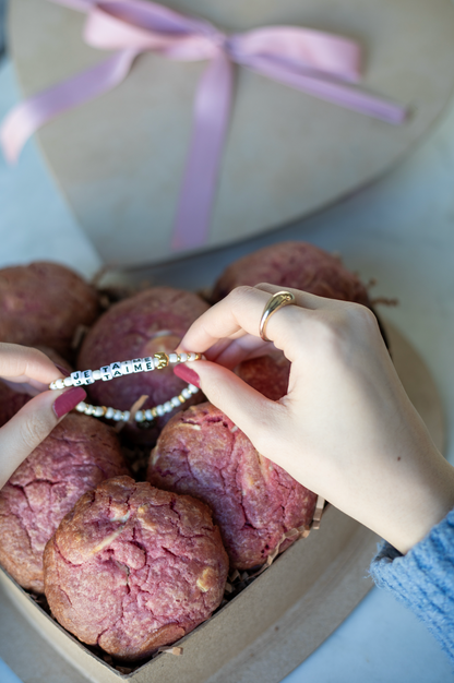 Heart-shaped box with nutty chocolate chip and white chocolate raspberry rose cookies; tied with pink ribbon - featuring je taime little words project bracelet
