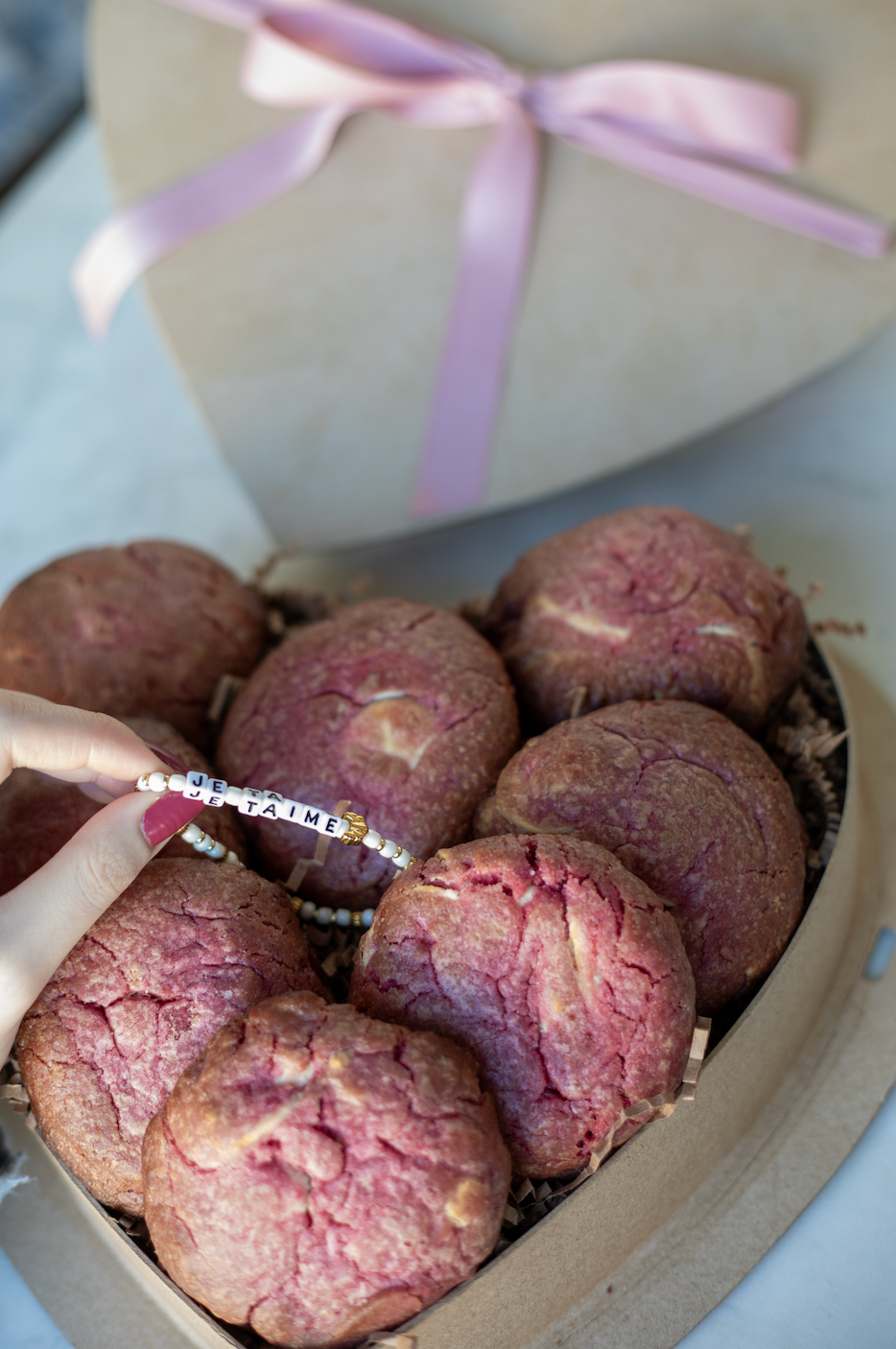 Heart-shaped box with nutty chocolate chip and white chocolate raspberry rose cookies; tied with pink ribbon - featuring je taime little words project bracelet