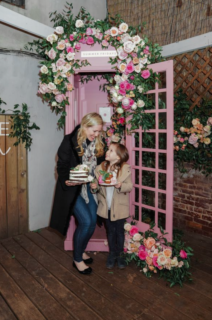 Woman and little girl holding cakes. 