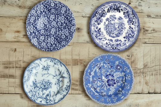 maman blue and white floral salad plate set — all four plates on table